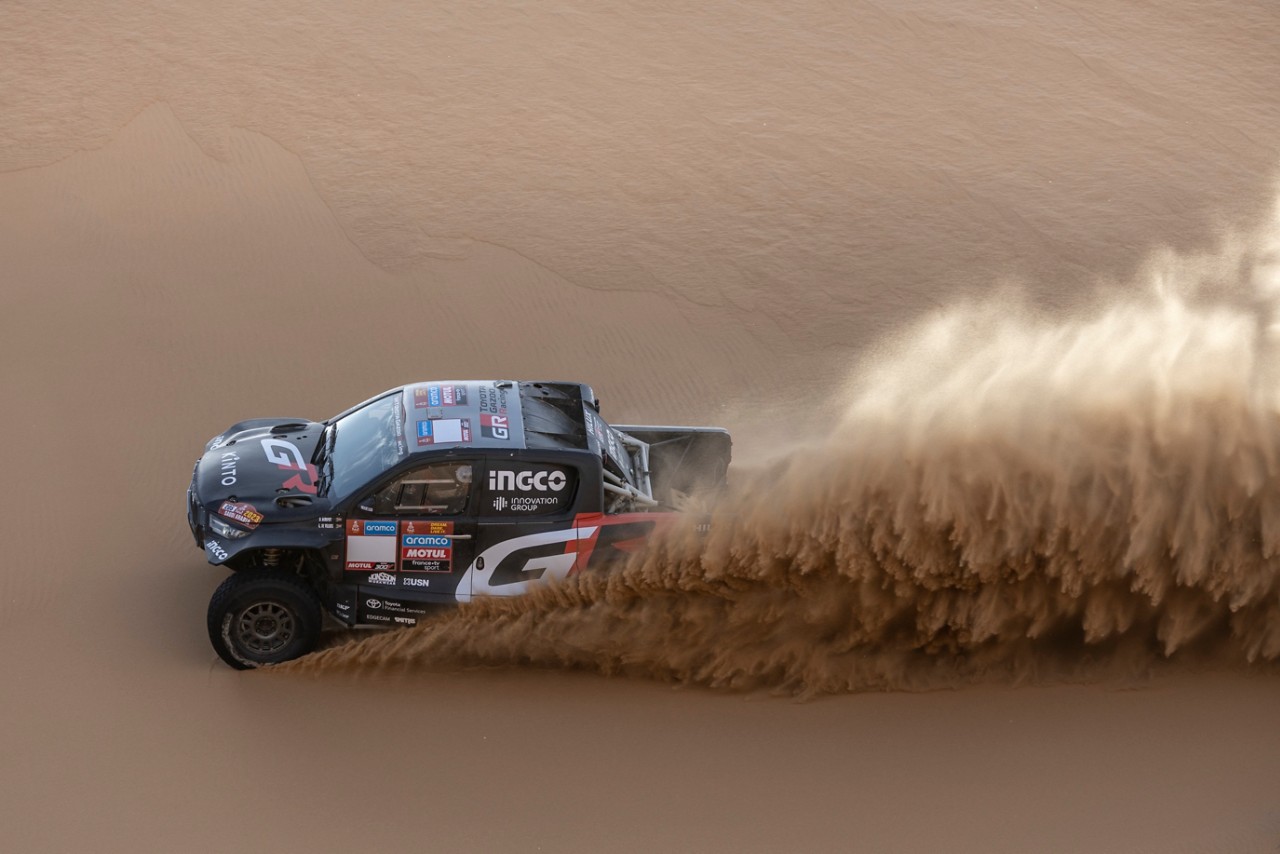 Hilux gliding through the air in desert